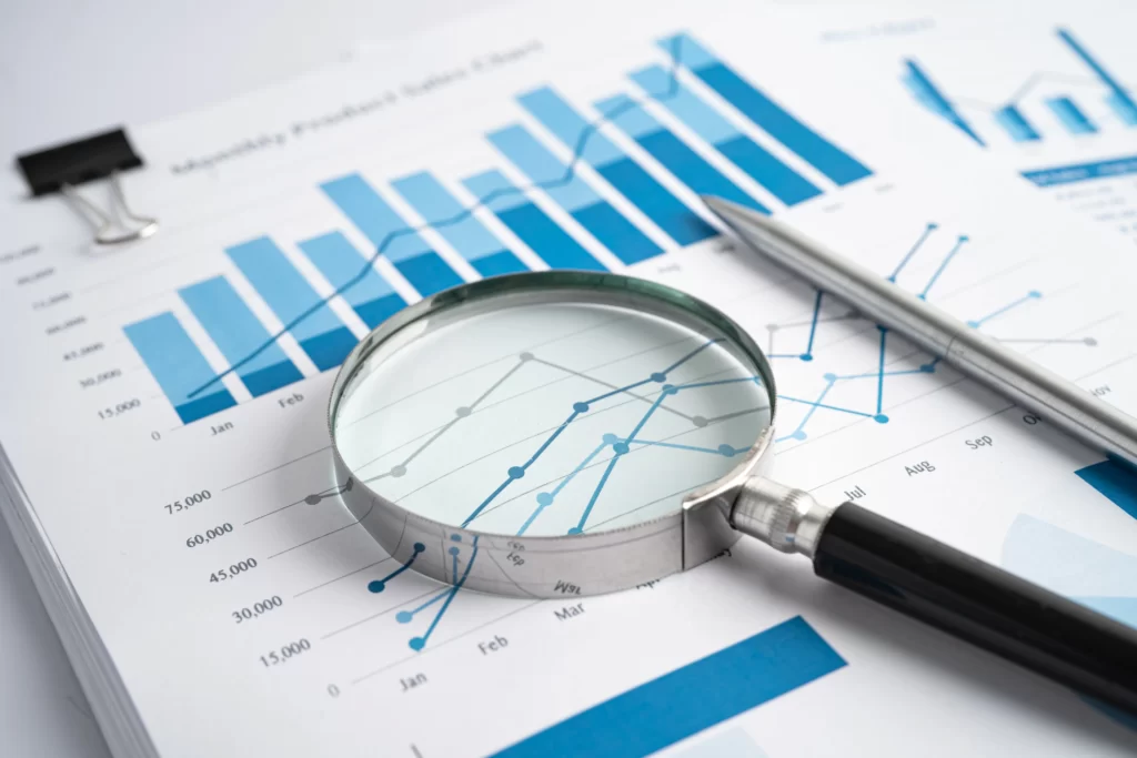 magnifying-glass-on-charts-graphs-paper-financial-2022-12-10-01-12-10-utc